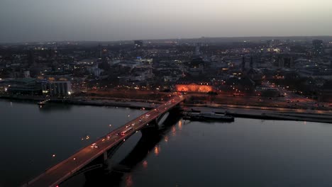drone flight by night over mainz right after magic hour on a warm spring day showing the city of biontech in the back