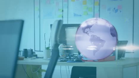Animation-of-rotating-globe-and-media-icons-over-businessman-at-desk-using-computer
