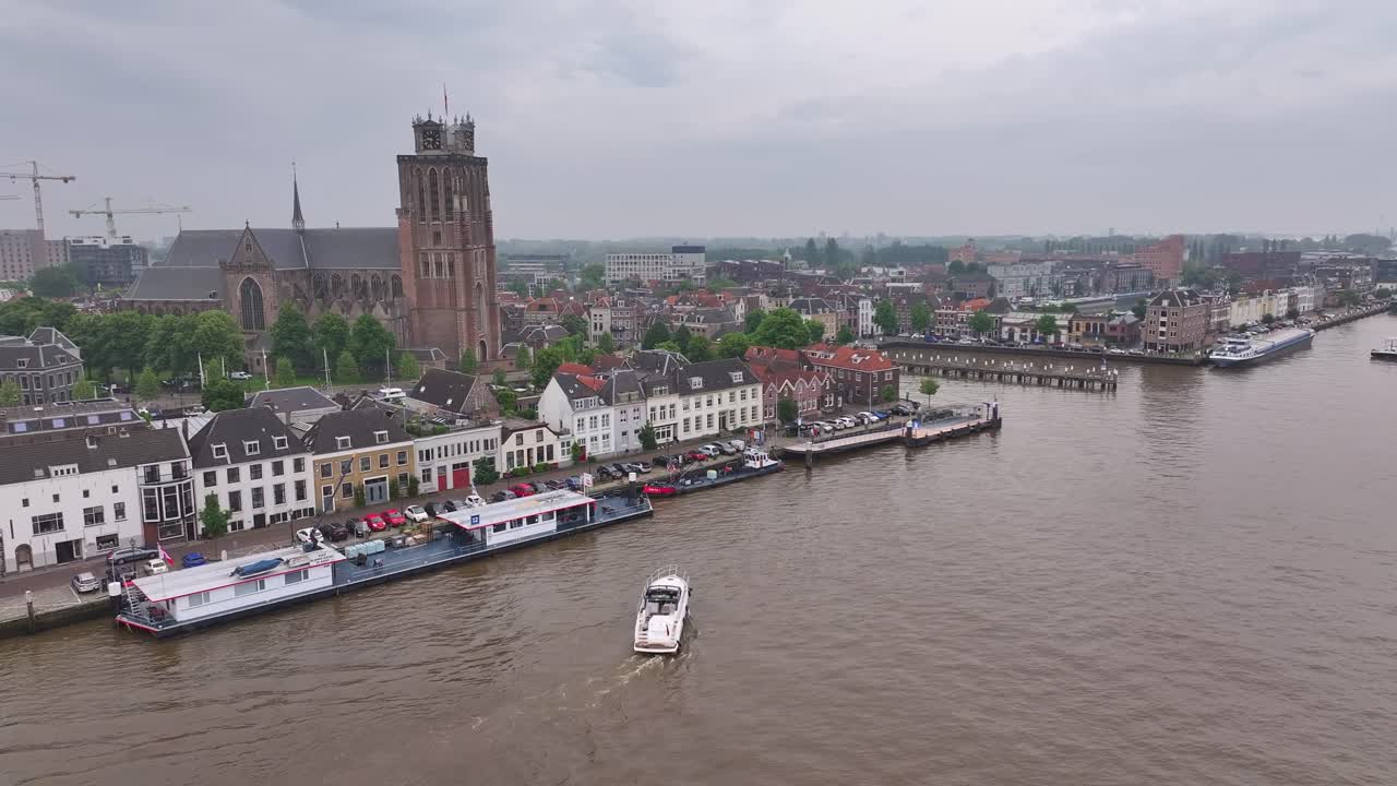 Panoramic View of a European City with River, Historic Buildings, Church, and Bridge