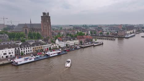 panoramic view of a european city with river, historic buildings, church, and bridge