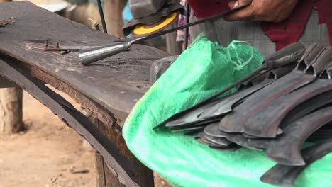 close shot of angle grinder sharpening a blade in a workshop