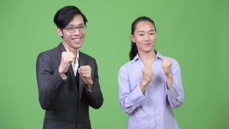 young asian business couple ready to fight together