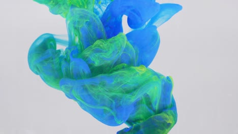 liquid abstractions, the dissolution of blue, yellow and green paint in water