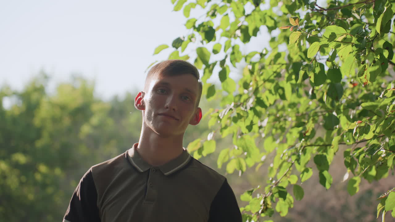 Youth With Sunglasses, Young Man Adjusting Sunglasses Outdoors, Close Shot Of Person Lifting Sunglasses Near Foliage, Profile View Of Youthful Individual With Reflective Expression Outdoors