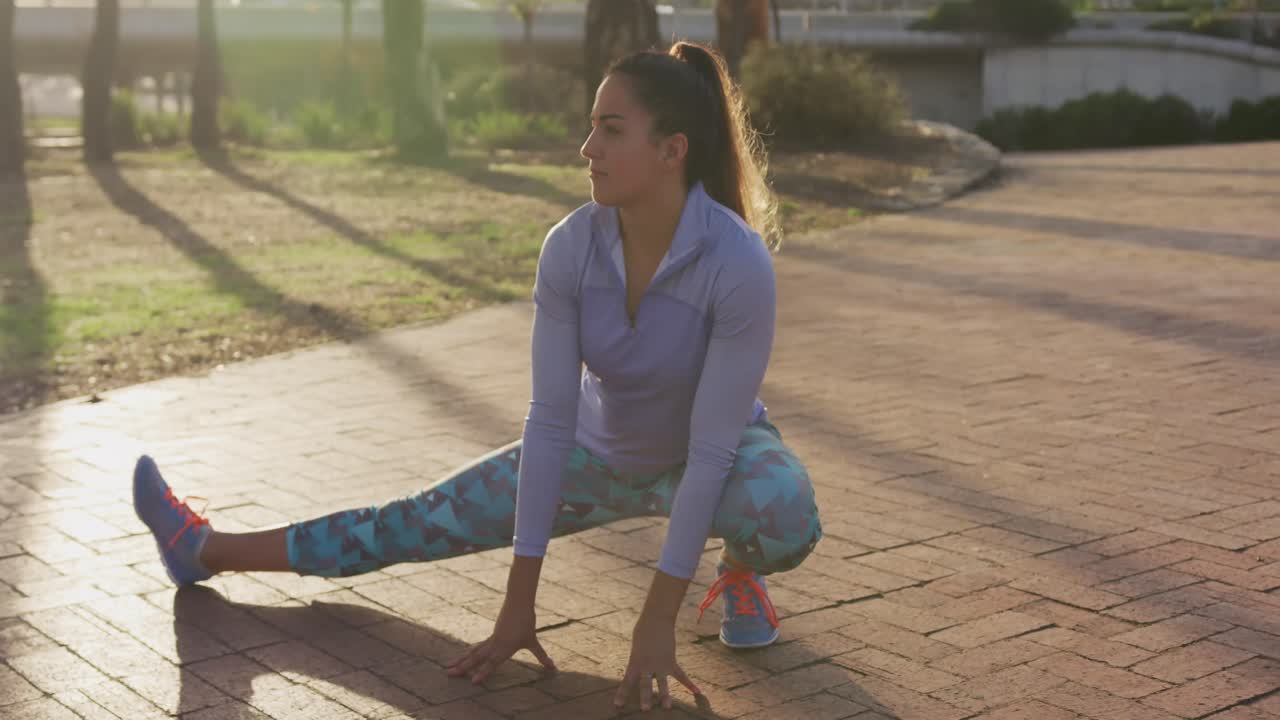 Caucasian woman stretching in a park