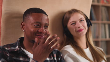 a smiling couple listening to music together