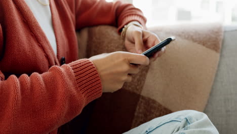 Hands,-phone-and-woman-on-sofa-typing-on-social