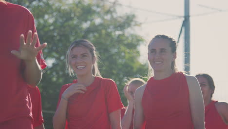 female soccer team warming up in training against flaring sun