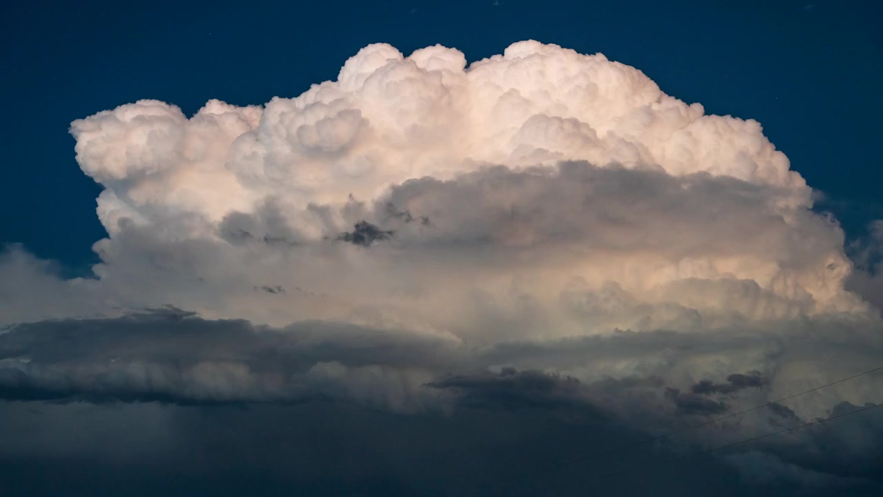 Massive thunderstorm clouds and flashing lightning powerful atmosphere