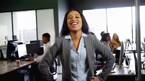 businesswoman standing with hands on hip in office 4k