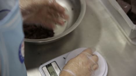 chocolate cookie dough being weighed into individual portions for baking - isolated