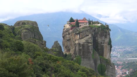 a cable car moves across a chasm to a monastery in meteroa greece