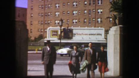 1957: family walking 50s style advertisement billboard background.