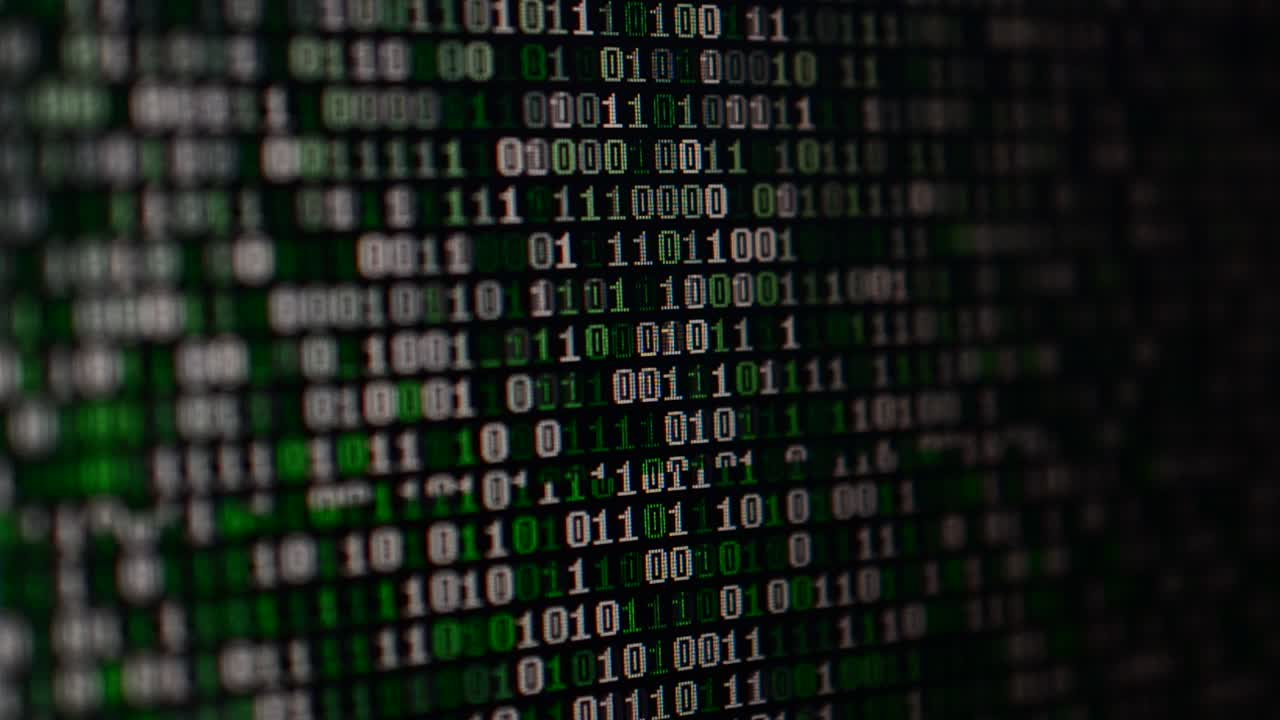 Binary code on the monitor screen. Shooting of a binary code, background
