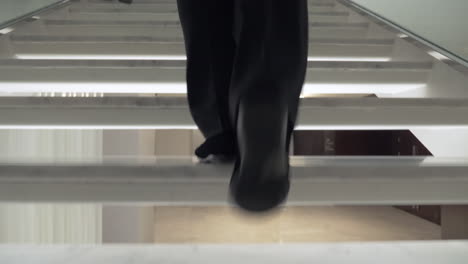 Woman-walking-up-white-stairway-in-the-hotel