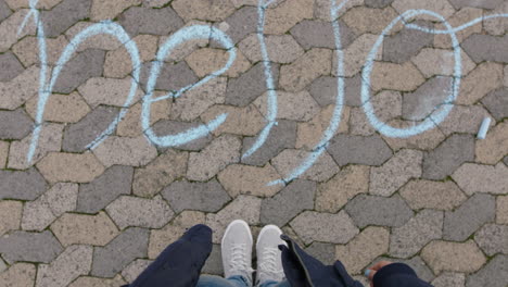 top-view-woman-looking-at-chalk-writing-hello-happy-teenage-girl-on-playground-concept