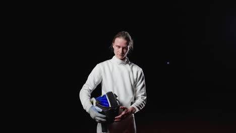 woman fencer holding helmet