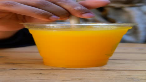 person drinking orange juice