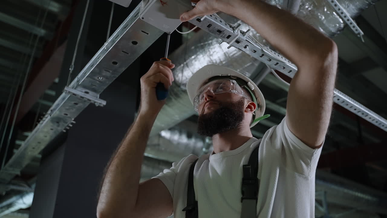 Electrician Working on Ceiling Fixture