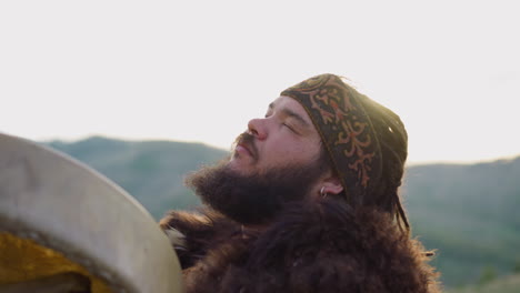 Bearded-man-plays-shamanic-drum-dancing-in-ecstasy