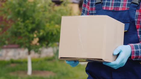 a courier with a parcel walks along the street