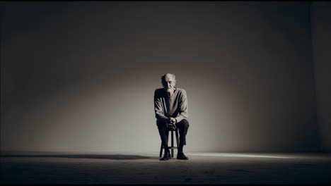 older man seated in studio