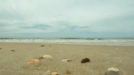 waves on a sandy beach are coming, summer in sylt, north sea, germany