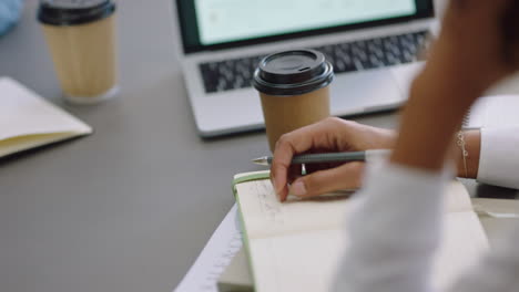 business-woman-hands-writing-taking-notes-in-corporate-meeting-using-pen-close-up