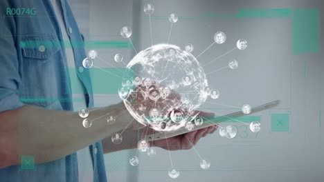 animation of globe with numbers over hands of caucasian man working on tablet