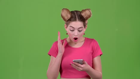 woman looking at her phone with surprised expression