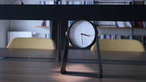 modern table clock in a library-like setting