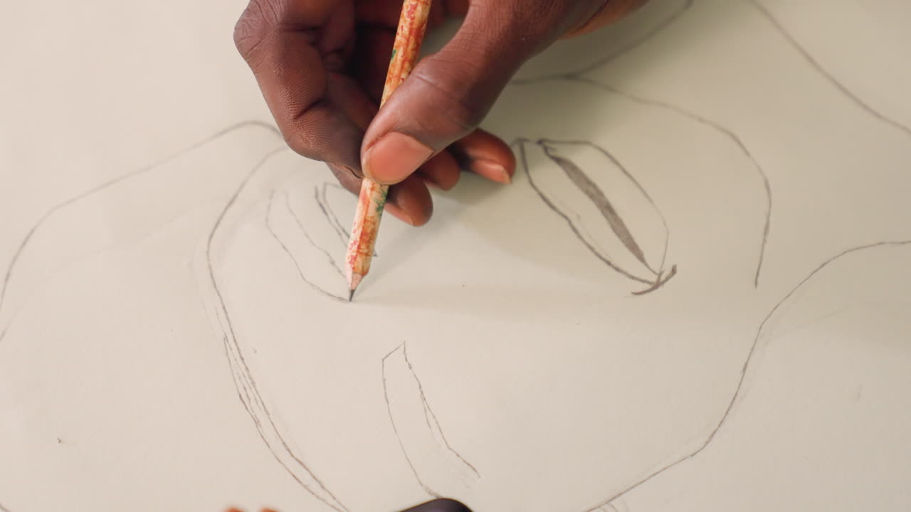 Black artist sketching portrait on paper, closeup of pencil outlines, focused hand tracing facial features, smartphone peeking at corner, soft studio light and calm atmosphere preparing for painting