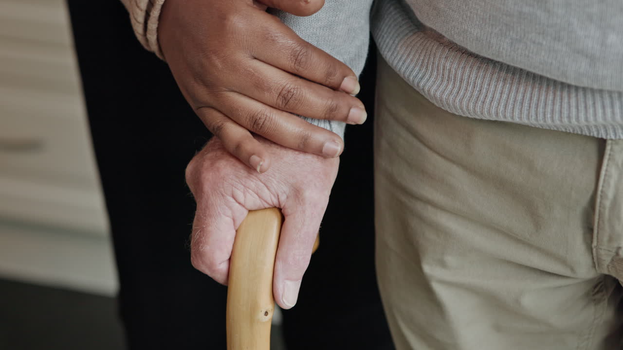Hands holding a cane showing care and support