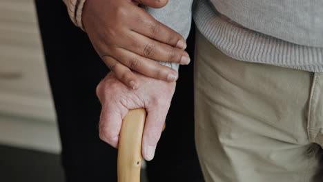 hands holding a cane showing care and support