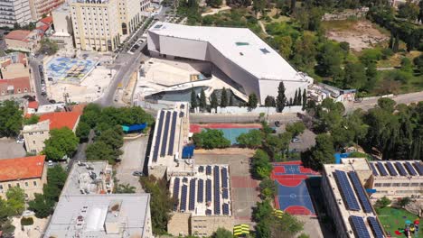 aerial view of jerusalem cityscape featuring the supreme court, solar panels, and urban green spaces