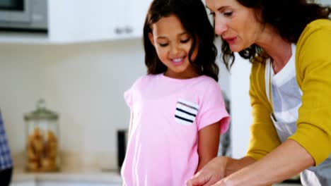 Madre-Cortando-Verduras-Mientras-Su-Hija-Mira-En-La-Cocina