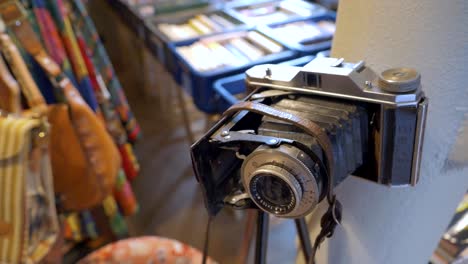 Old-camera-against-a-background-of-colorful-antiques