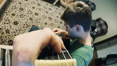 boy plays a classical guitar