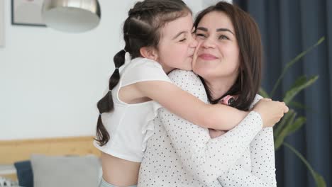 happy child who loves a young mother they play and pretend to fly happy child who loves a young mother they spend time together cheerful mother holds her daughter on her back pretending to fly mothers day