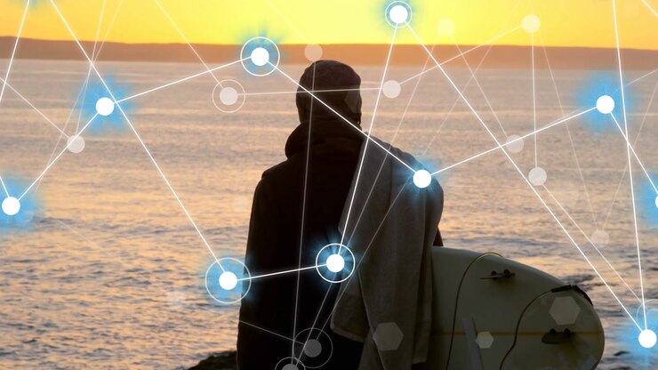Man with surfboard on rocky shoreline, animated nodes fading in crossing torso mapping tech