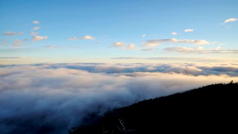 time lapse of clouds flowing over mountains