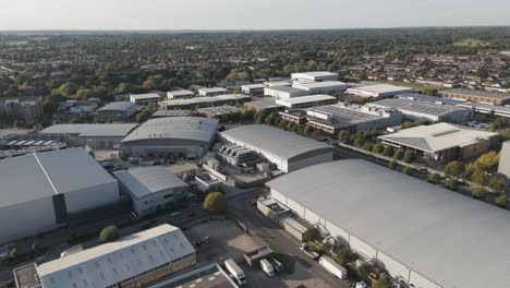 rising aerial view capturing slough trading estate bathed in warm golden hour light, showcasing industrial architecture and commercial infrastructure