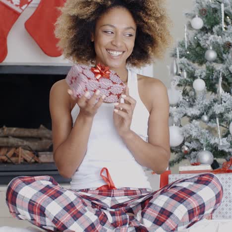 Happy-young-woman-holding-her-Christmas-gift