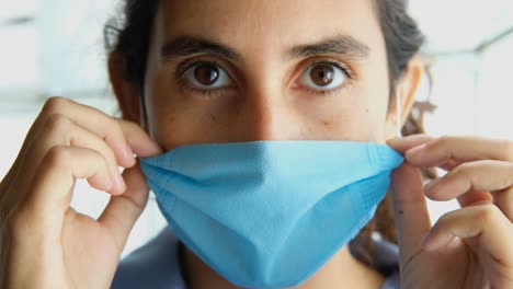 female doctor shows how to put on medical mask on the face correctly