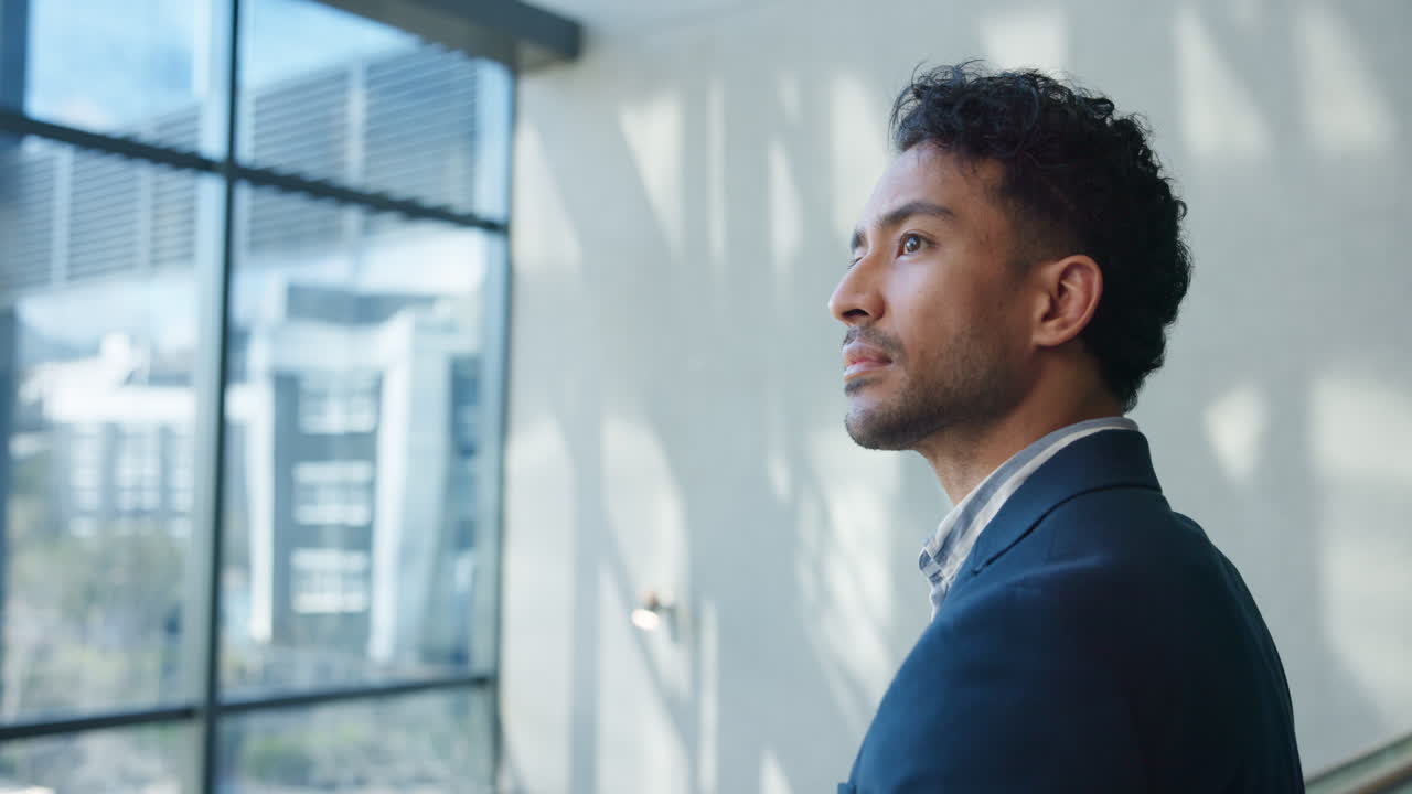 Man in Suit Looking Out Window