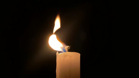 close up of single candle getting blown out