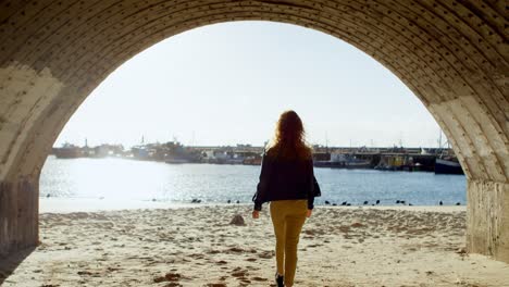 Woman-standing-with-arms-out-stretched-at-dock-4k