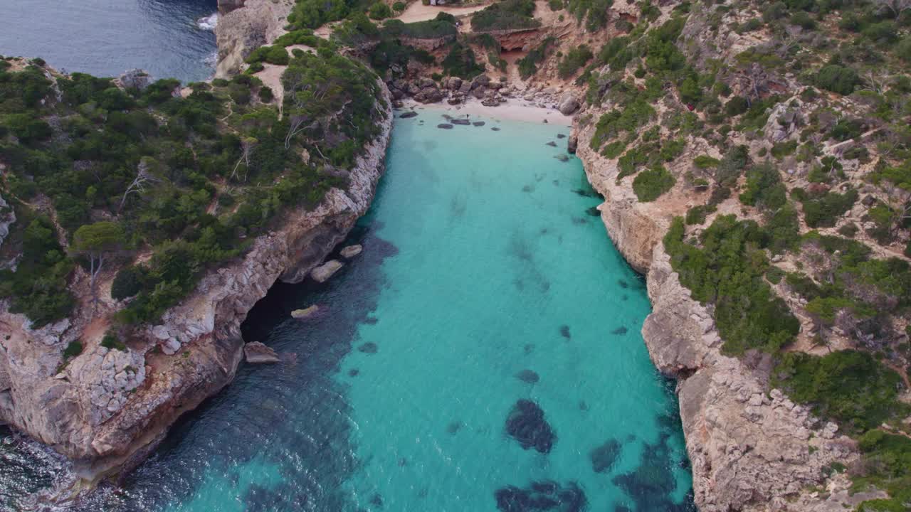Tilt up shot of cove Cala S&acute;Almonia Mallorca with no people, aerial