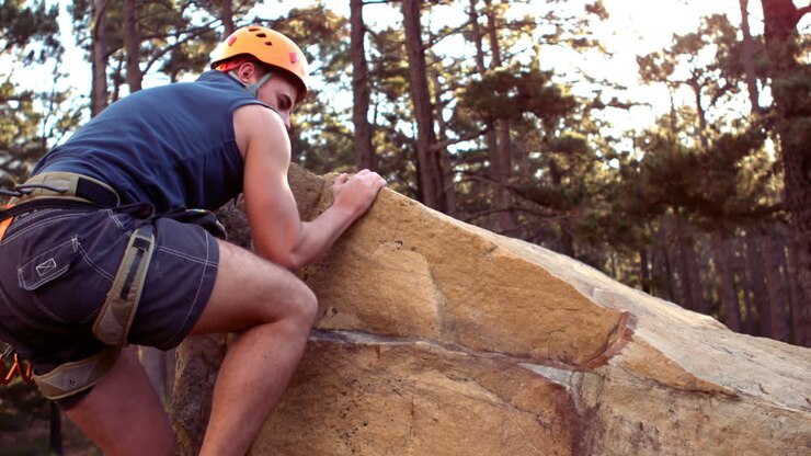 Man rock climbing in wilderness