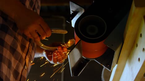 female metalsmith using sharpening machine 4k